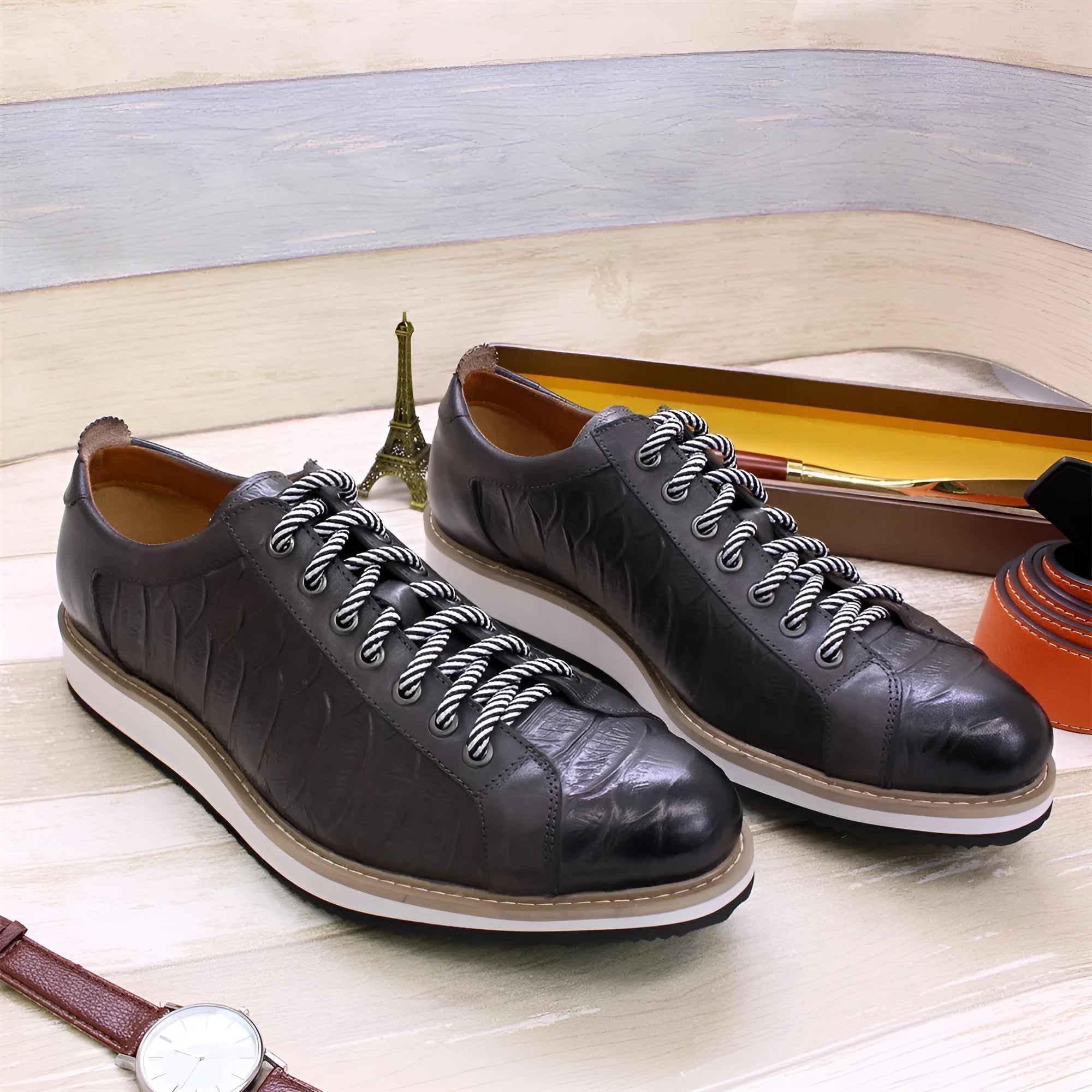 Men's low-top black embossed pattern handmade lace-up shoes on a white background.