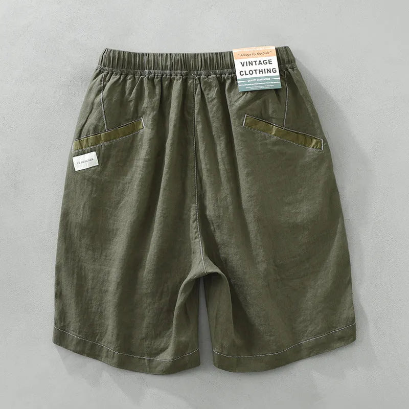 Men's linen shorts in straight drooping style with drawstring waist, shown in green and black colour options