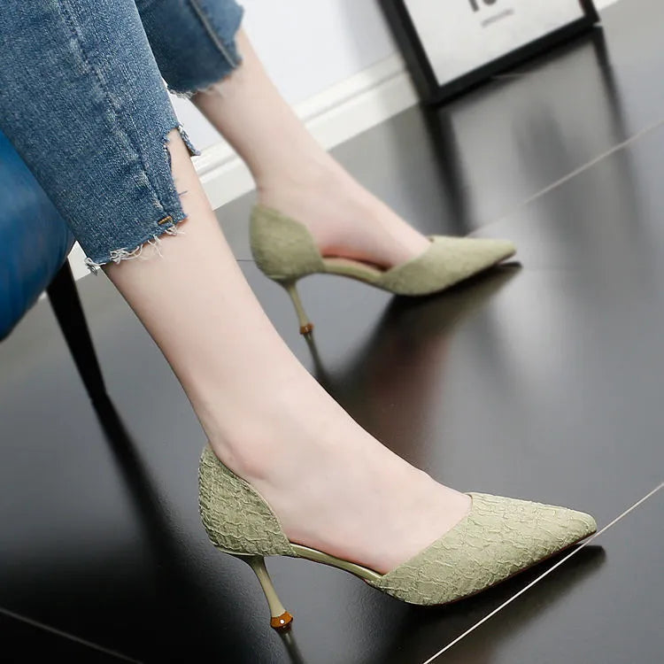 Black pointed toe stiletto high heel shoe on a white background.