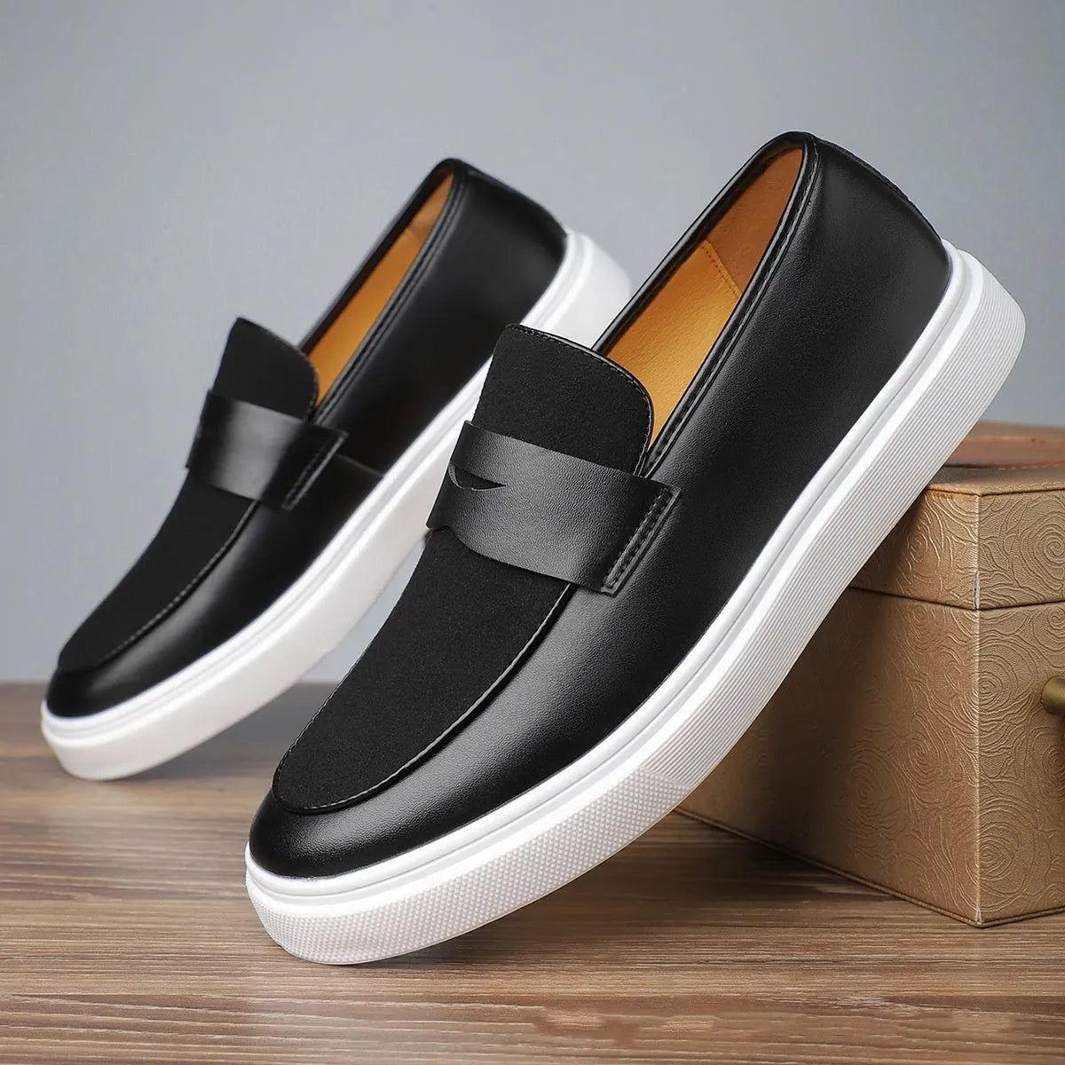 Black men's slip-on casual shoes with tassel detailing and Gommino soles