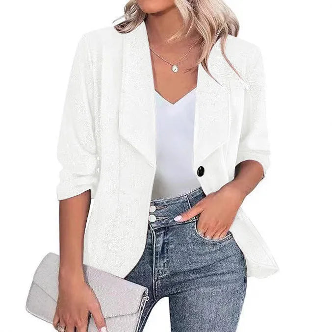 Slim-fitting black polyester suit jacket with long sleeves on a hanger.