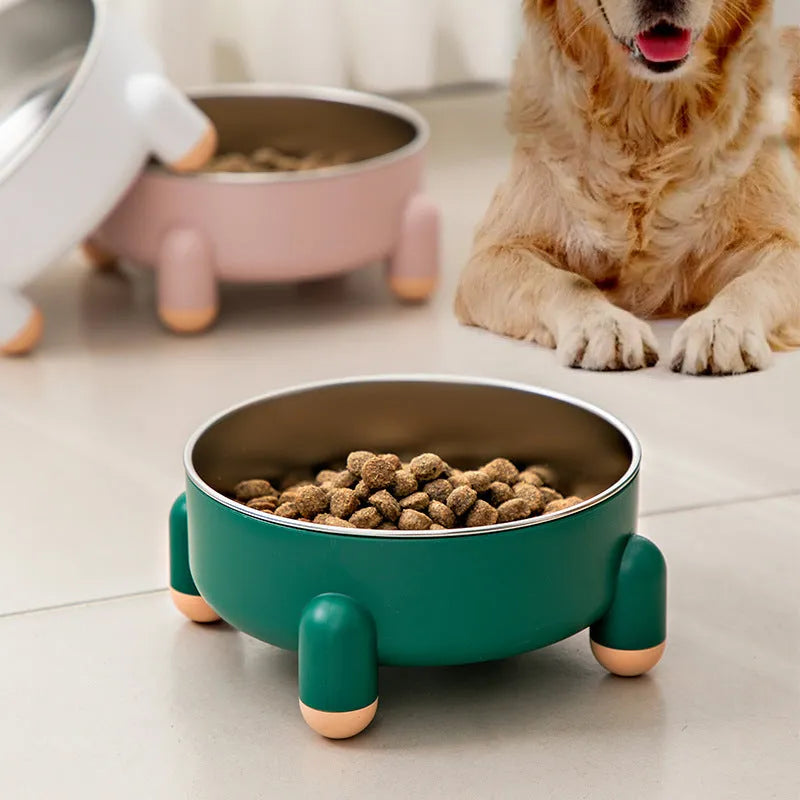 Green stainless steel pet bowl with non-slip base and high foot on a kitchen floor.