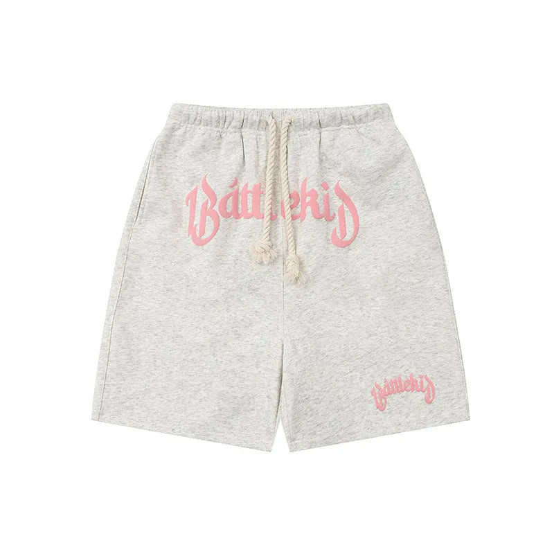 Man wearing loose-fit black cotton-blend cropped shorts in a streetwear style.