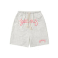 Man wearing loose-fit black cotton-blend cropped shorts in a streetwear style.