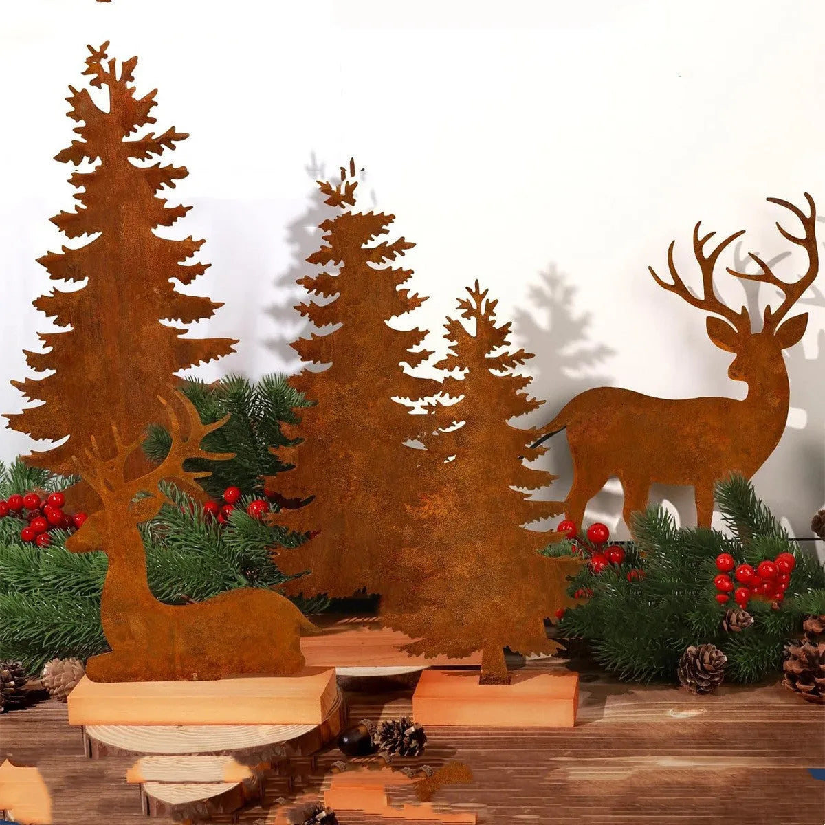 Three rusty metal Christmas ornaments featuring elk and tree silhouettes on a white background