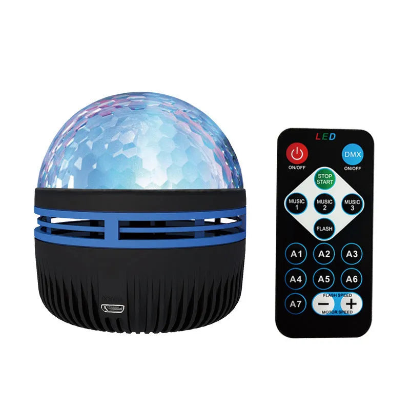 Silver LED galaxy projector lamp with acrylic shade on a table, showing starry light projection on a blue wall.