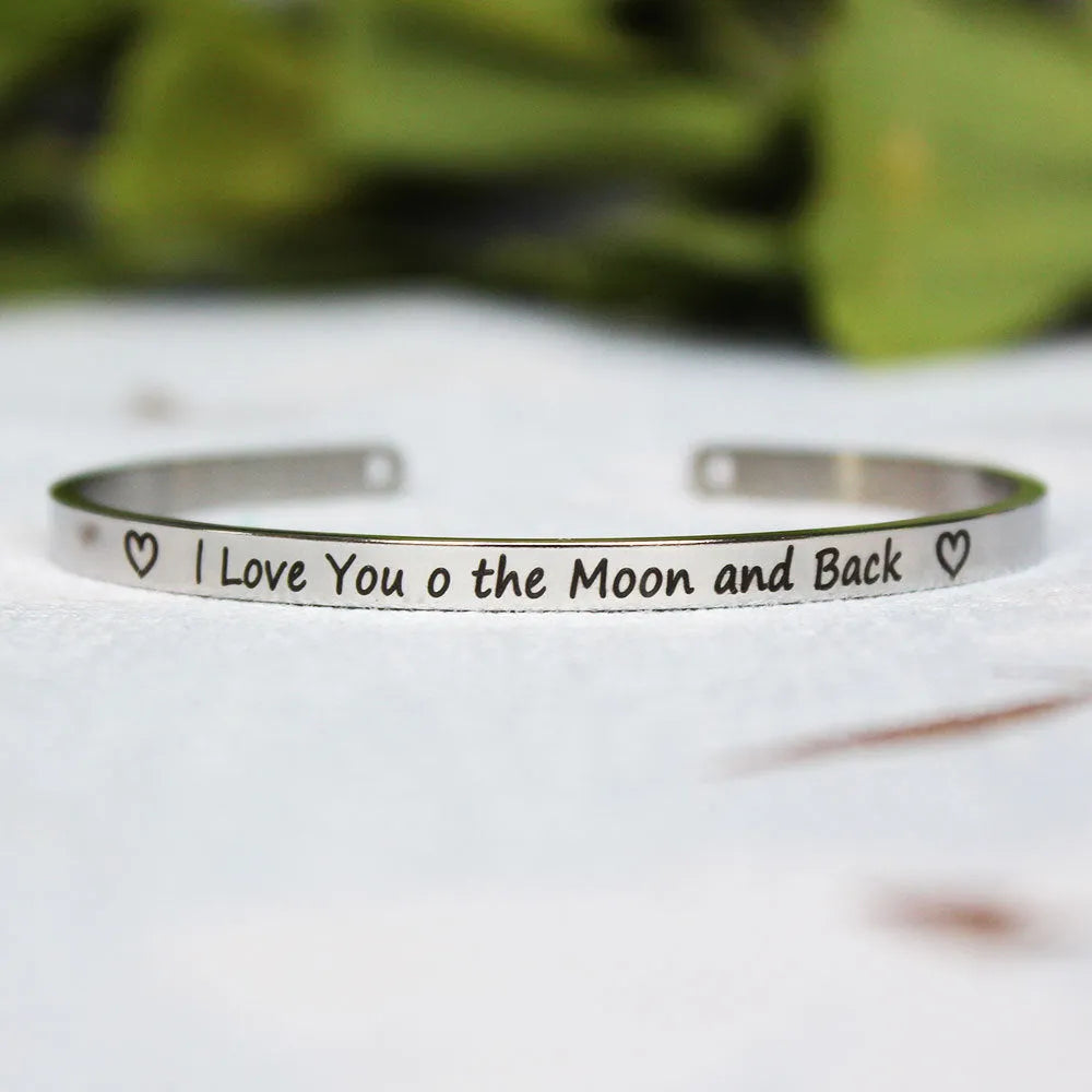 Silver customisable stainless steel bracelet with laser engraved text and adjustable fit on neutral background