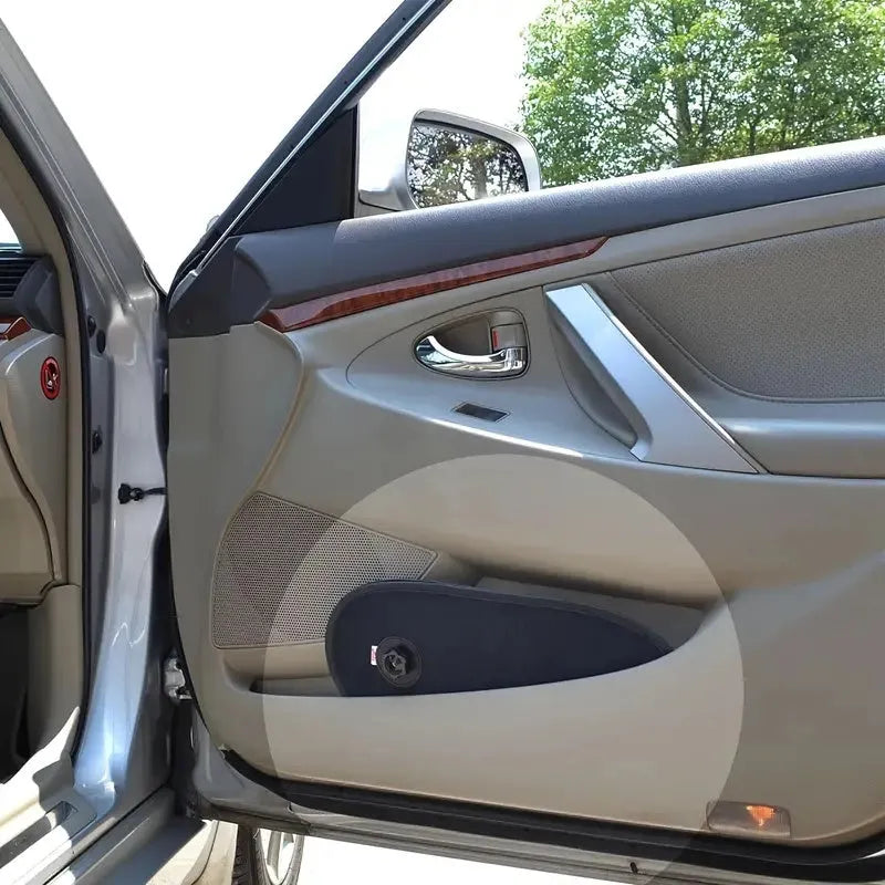 Black stretchy car side window shade with suction cups attached to glass, shown in a collapsed state.