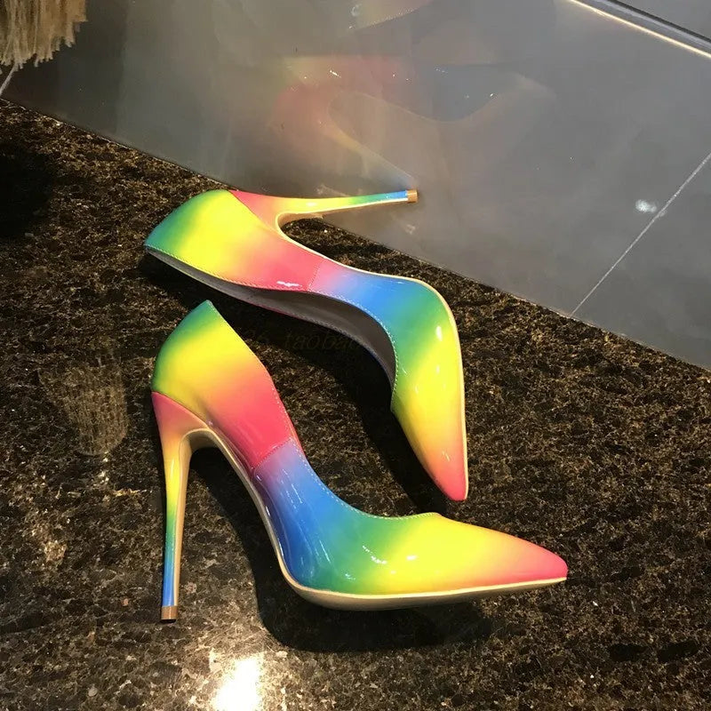 Rainbow coloured patent leather women's court shoes with a pointed toe and a thin ultra-high stiletto heel.