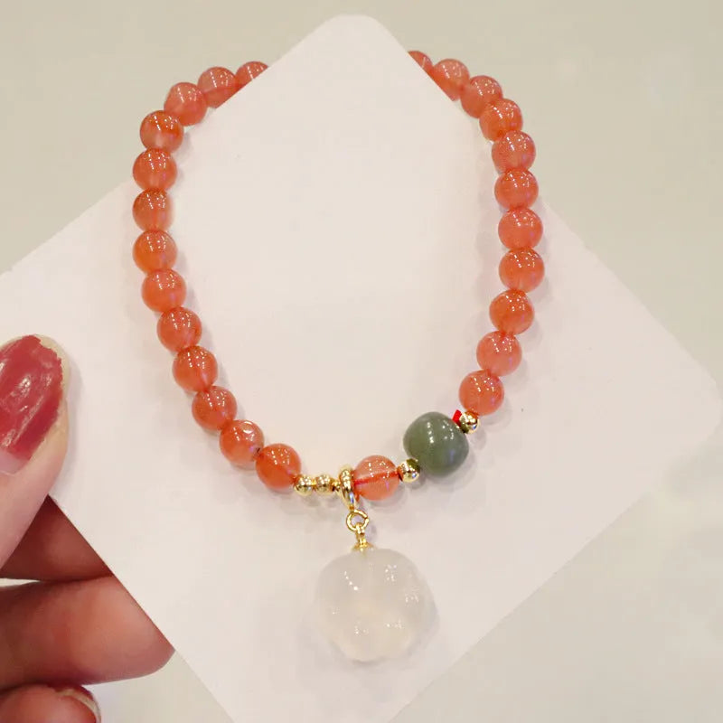 Women's natural red agate bracelet with 8mm cat's paw charms and complementary jade bracelet