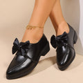 Women's British-style leather shoes with bow decoration, pointed toe, and slip-on design