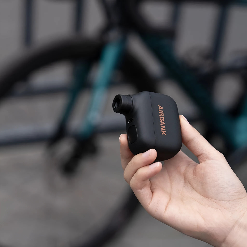 Black AS100 electric bicycle inflator pump with USB cable and waterproof storage bag