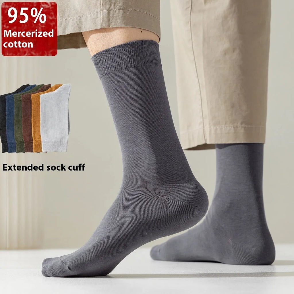 Men's mid-calf combed cotton socks in solid colours like army green, beige, and black on a white background.