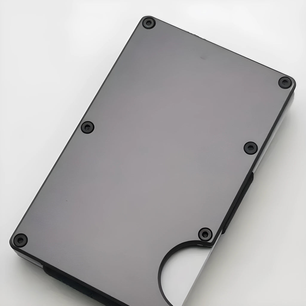 Carbon fibre credit card wallet in aluminium alloy grey, showing slim profile and card slots.