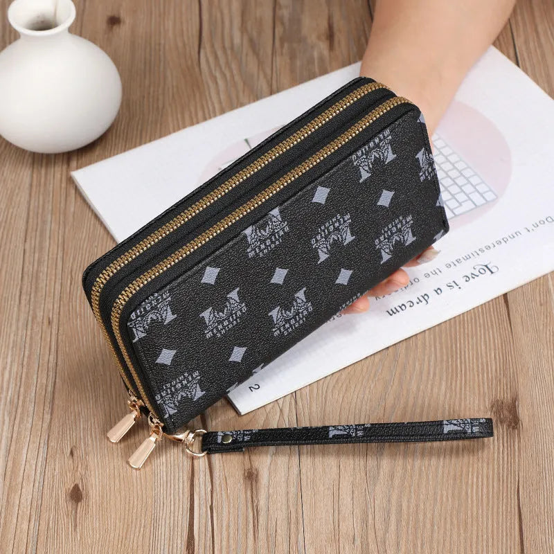 Long black PU leather wallet clutch with phone slot, card holders, and zippered coin purse