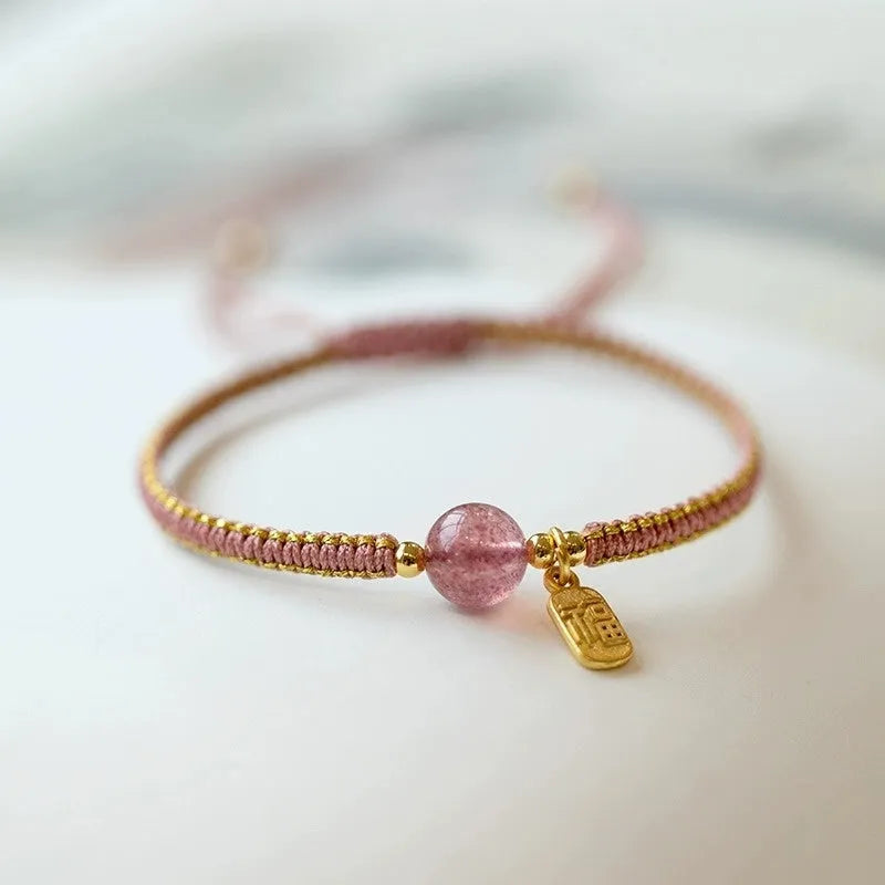 Adjustable red rope bracelet with strawberry quartz transfer beads and sliding knot closure