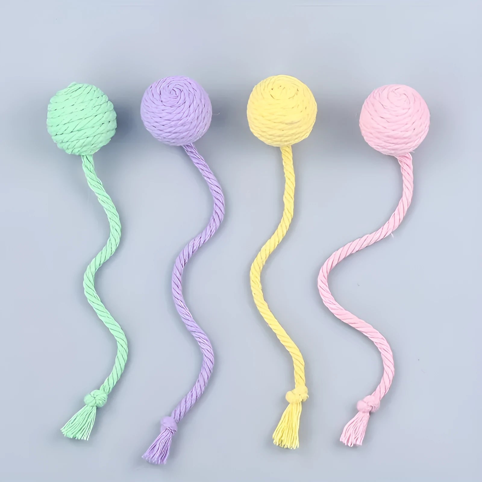 Colourful cat toy ball with rope attached and internal bell for kitten play stimulation