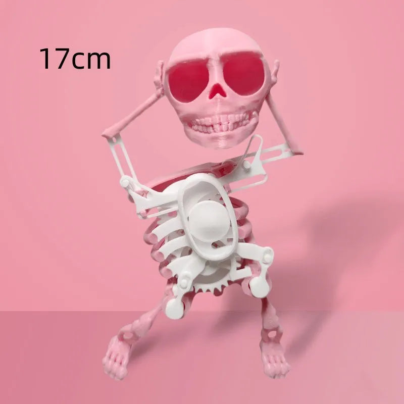 3D printed dancing skeleton gravity toy in pink and white, 22cm tall, on a desk