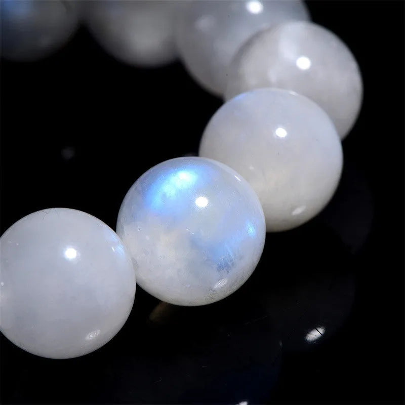 Polished moonstone bracelet with round blue beads showing natural colour variations
