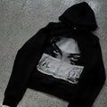 Women's black hoodie with a cartoon pattern print, loose fit.