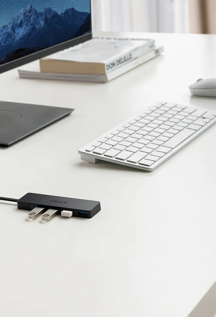 Black Anker 4-port USB 3.0 data hub with attached cable, showing four USB Type-A ports.