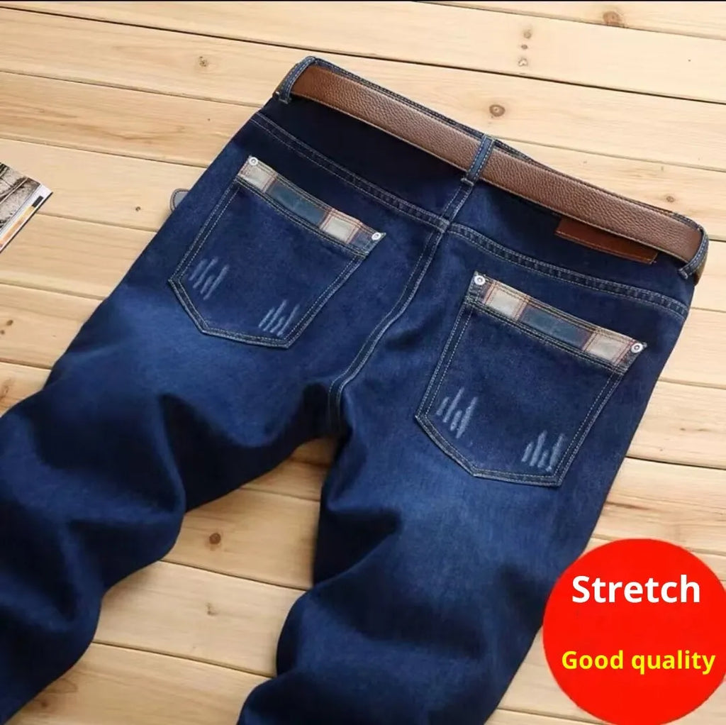 Men's dark blue slim-fit stretch skinny denim pants with zipper fly, side view