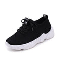 Women's white thick-soled woven sports shoes with front strap on a light background.