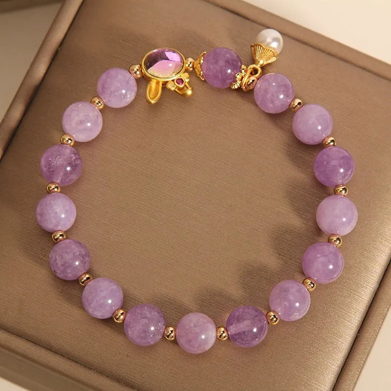 Purplish red mauve jade rabbit head charm on a crystal adjustable Mori-style bracelet.