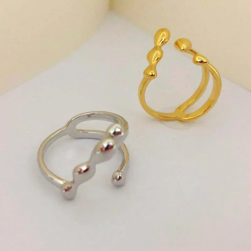Brass fashion ring with spherical elements in circular design available in gold and silver colours