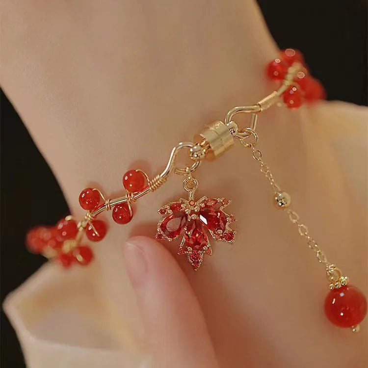 Red ginkgo leaf charm on a silver-toned magnetic alloy bracelet in Chinese natural style.