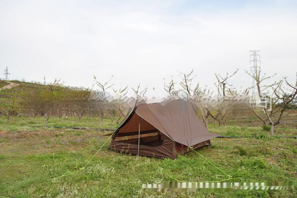 Brown A-line hiking tent erected with hiking poles showing spacious interior for 2-3 people