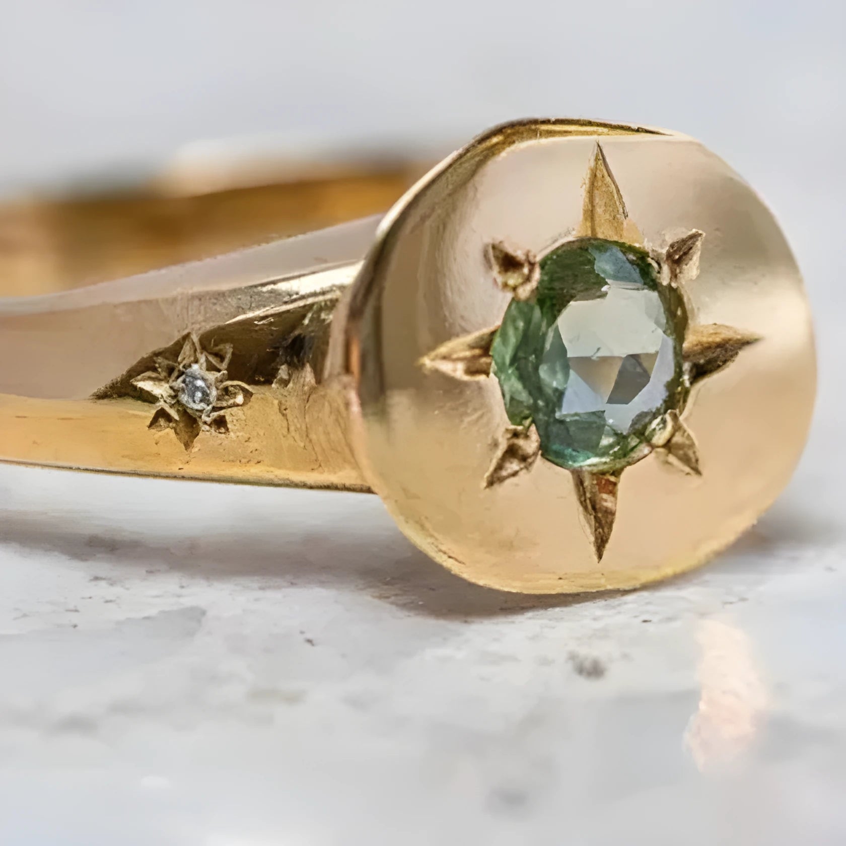 Gold-coloured adjustable ring with a central oval star-shaped zircon stone on a simple band.