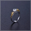 Copper crown design crystal ring in black gold finish on a size chart.