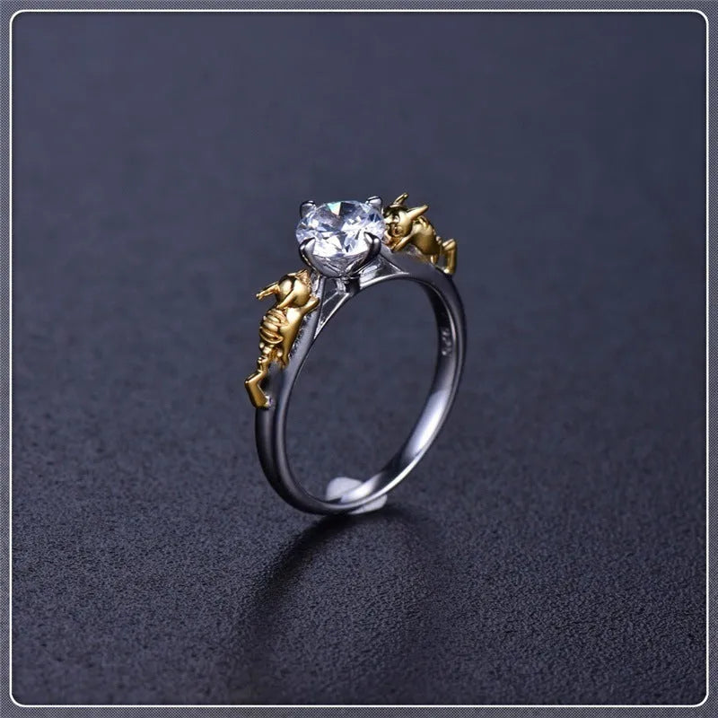 Copper crown design crystal ring in black gold finish on a size chart.