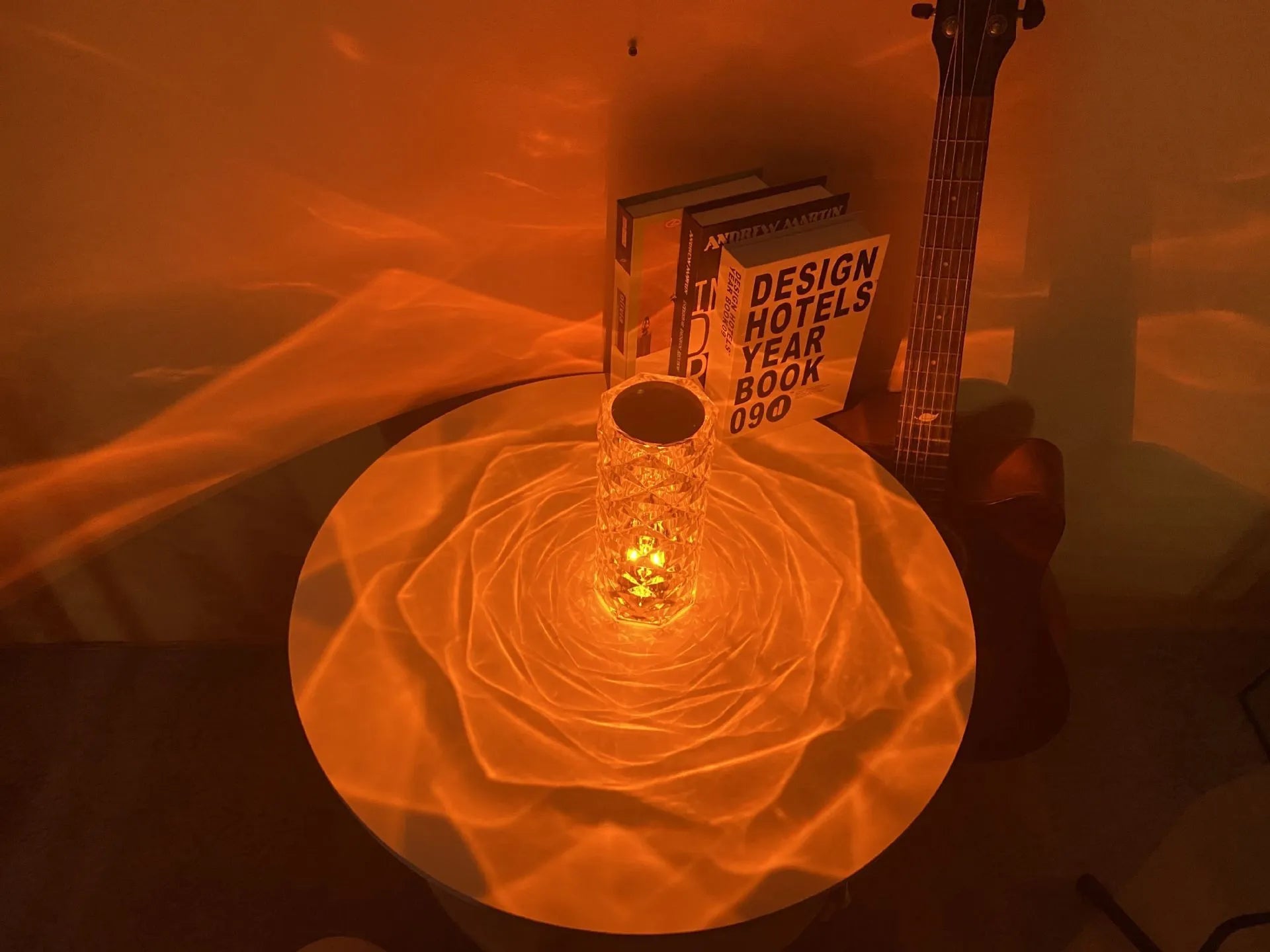 LED rose diamond shaped table lamp with acrylic construction and three-tone lighting on a wooden surface.