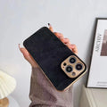 Solid colour leather texture TPU phone case for iPhone on a table, showing grey-green colour option.