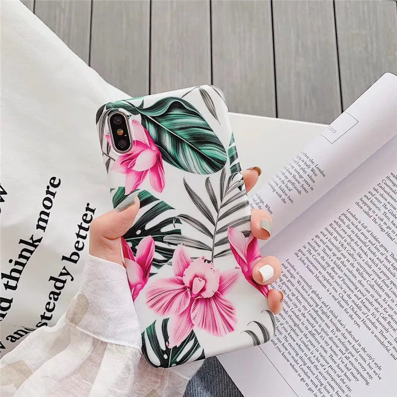 Pink floral TPU phone case for iPhone models on a table