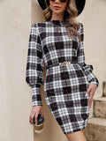 A black tight-fitting dress with lantern sleeves and decorative leather stitching, modelled on a mannequin.