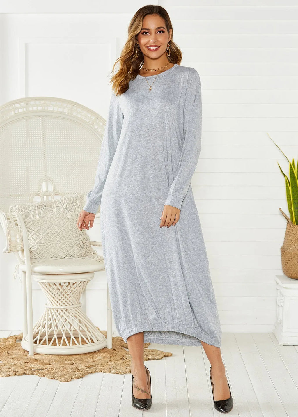 A loose long lantern dress with a lace-up crew neck, shown in grey.