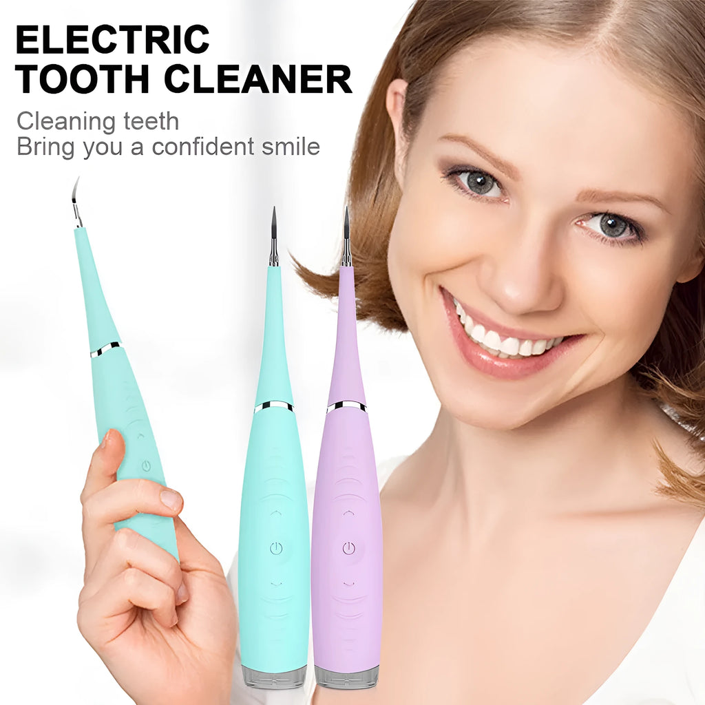 Pink and blue waterproof electric tooth scaler with integrated handle on a bathroom counter.