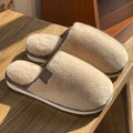 Pair of solid colour plush PVC winter slippers with non-slip soles for home use.