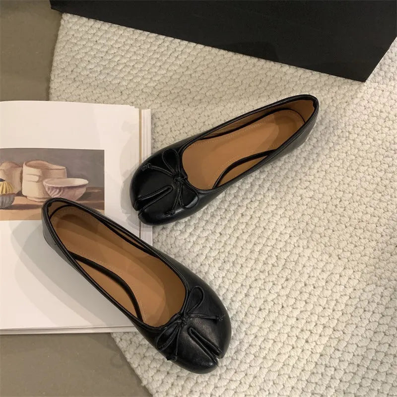 Women's split-toe flat pump shoes in beige with a round toe and shallow cut.