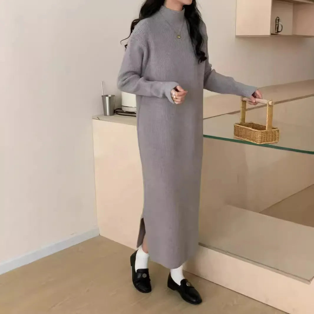 Woman wearing a milky white half turtleneck acrylic knit dress with a high waist and overknee A-line skirt.