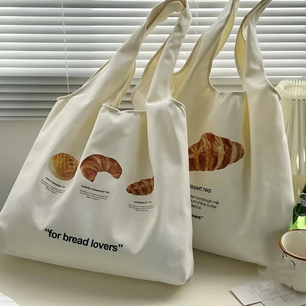 Beige canvas shoulder bag with bread design showing 44cm width and adjustable shoulder strap