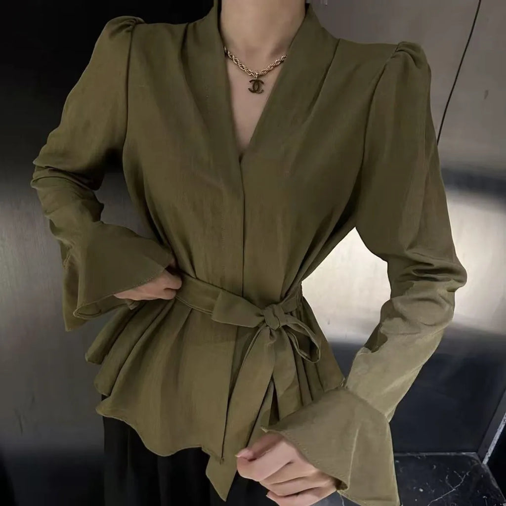 Women's black French-style shirt with irregular collar, tied front, and long flared bell sleeves