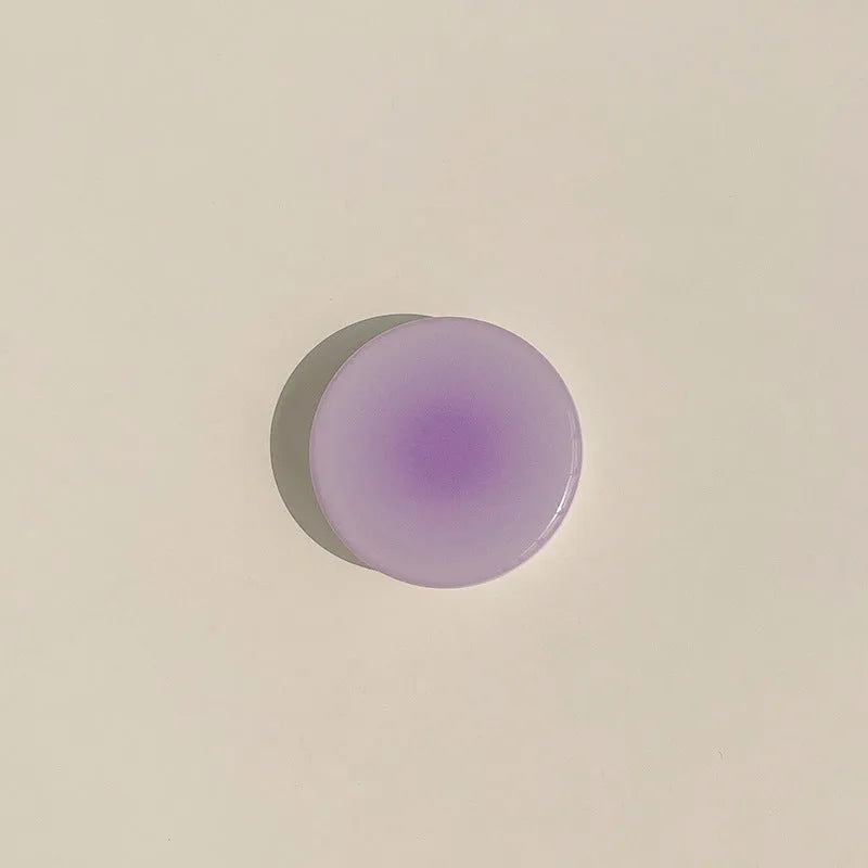 Yellow-purple gradient silicone iPhone case with retractable viewing bracket shown on mobile phone