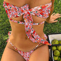 A blue printed one-piece swimsuit for women with a lace-up front and built-in padding.