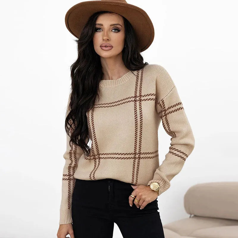Women's loose fit crew neck sweater in a colour-block plaid pattern with apricot, black, beige, red, and green stripes.