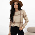 Women's loose fit crew neck sweater in a colour-block plaid pattern with apricot, black, beige, red, and green stripes.