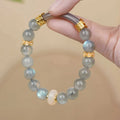 Gray moonstone agate women's half bracelet with 8mm round beads on a wrist.